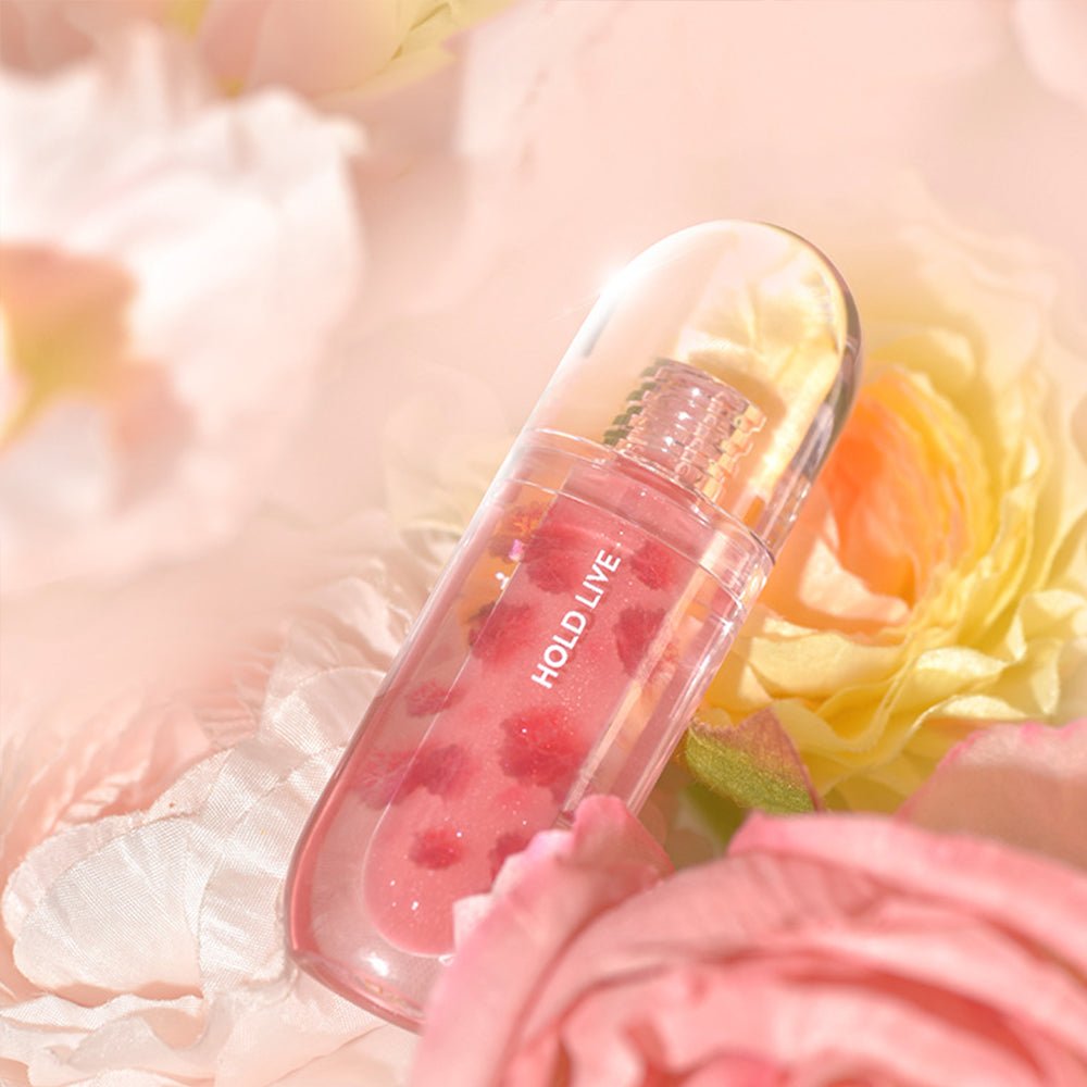 HOLD LIVE hydrating lip gloss with blurred background