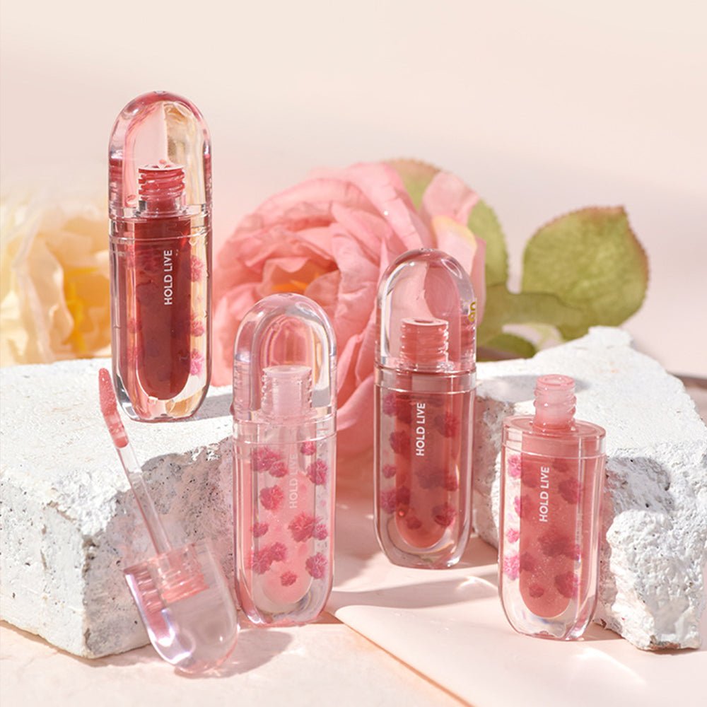 HOLD LIVE lip gloss collection with floral accents